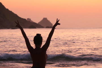 Happy woman on the beach with sunset in  Fernando de Noronha