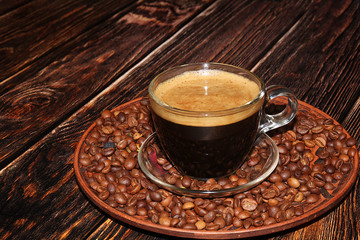 Cup of hot latte coffee on a dark wooden table with grains, selective focus. Comfort and warmth in the house in the cold autumn,