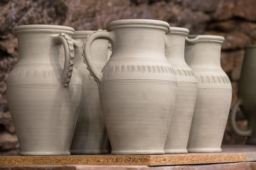 Fototapeta na wymiar Pottery handmade. Exhibition and sale old fashioned clay pitchers handmade 