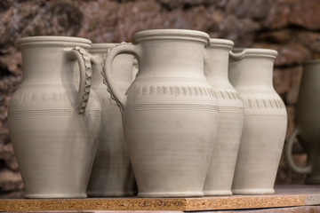 Fototapeta na wymiar Pottery handmade. Exhibition and sale old fashioned clay pitchers handmade