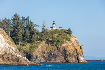USA, Washington State, Ilwaco, Cape Disappointment State Park. Cape Disappointment Lighthouse on cliff above the Columbia River Bar and Pacific Ocean.