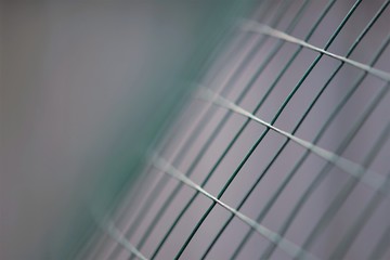 New green mesh fence, macro photo, selective art focus