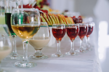 Festive table with cold exotic alcoholic beverages, cocktails and fruits. Celebration or other event