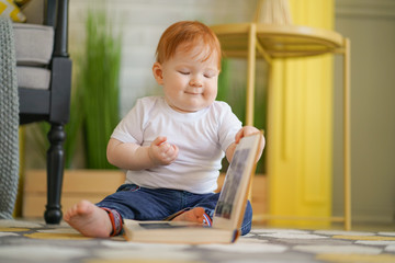 little infant Boy reading a book educating concept