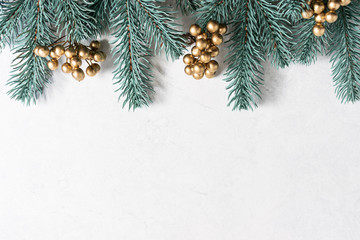 Christmas background with fir branches and golden berries with copy space for your text. Christmas greeting card template.