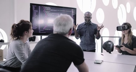 African American male game designer leading a meeting