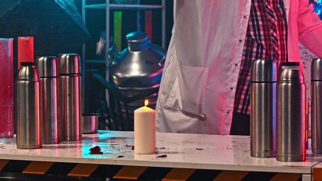 A man lighting up a balloon with gas inside of it and getting an explosion