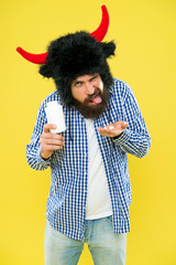 Protein supplement. Man hold vitamin or medicines bottle. Guy with horns symbol strength and power....