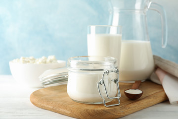 Fresh dairy products on white wooden table, copy space