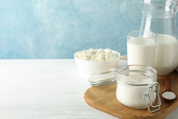 Fresh dairy products on white wooden table, copy space