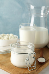 Fresh dairy products on white wooden table, copy space
