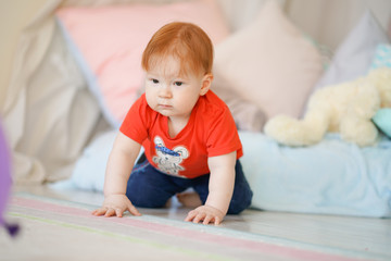 little baby crawling on the floor with carpet alone
