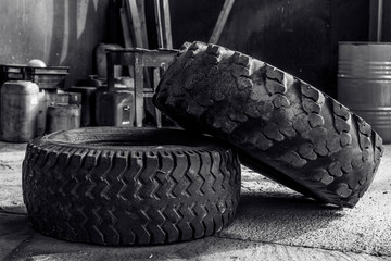 two old tires, from a truck, in an old workshop