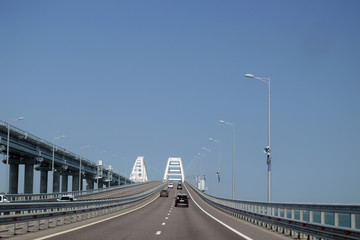 Fototapeta na wymiar Crimean bridge on a clear sunny day. Beautiful design. A railway bridge is being built nearby.