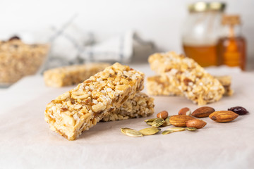 Healthy homemade granola bars with nuts, honey and dried berries on wooden table