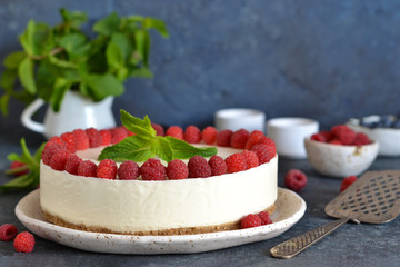 Vanilla cheesecake with raspberries on a stone background. New York cheesecake with raspberries.