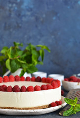 Vanilla cheesecake with raspberries on a stone background. New York cheesecake with raspberries.