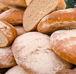 A large loaf of bread at a market table, rustic agriculture