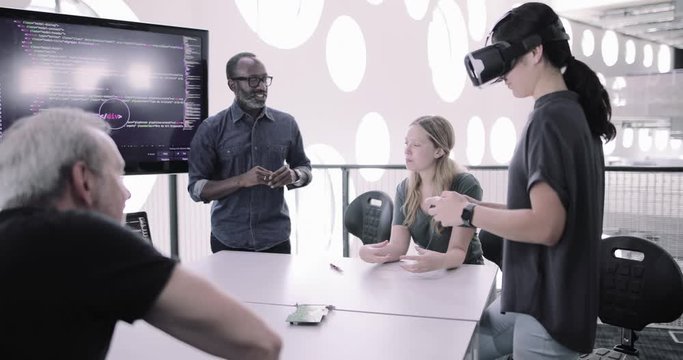 African American male game designer leading a meeting