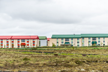 Fototapeta na wymiar Iceland hotel or apartment colorful houses in Scandinavian city with multicolored red green on painted roof