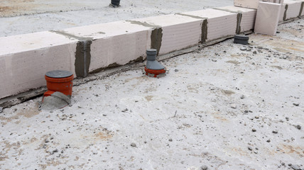 Installation of plastic sewer pipes. Install a new pipe. In the gray floor