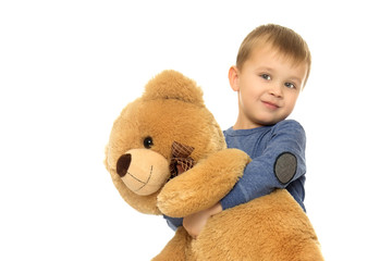 Little boy playing with teddy bear. Isolated on white background