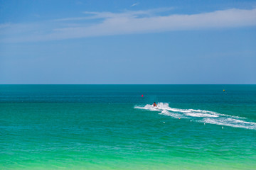 Fototapeta na wymiar The ocean is turquoise and the boat is far away. Thailand. Samui. Gulf of Thailand. Lamai Beach