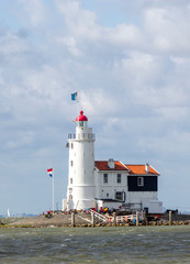 Fototapeta na wymiar Traditional lighthouse 'Het Paard van Marken' in Marken the Netherlands
