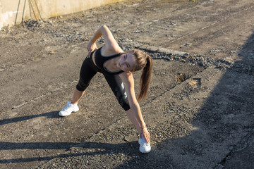 A young slim athletic girl in sportswear with snakeskin prints performs a set of exercises. Fitness...