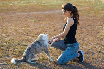 A young slim athletic girl in sportswear with snakeskin prints performs a set of exercises. Fitness and healthy lifestyle.	