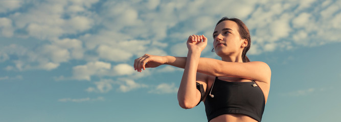 A young slim athletic girl in sportswear with snakeskin prints performs a set of exercises. Fitness...