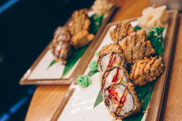 Sushi Warm Ebi Sake Unagi Spring plateau buffet in night dining restaurant flat lay. Delicious Smoked salmon rolls flesh seaweed and ginger. The norwegian salmon and Fish.