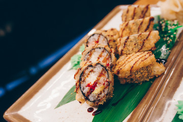 Sushi Warm Ebi Sake Unagi Spring plateau buffet in night dining restaurant flat lay. Delicious Smoked salmon rolls flesh seaweed and ginger. The norwegian salmon and Fish.