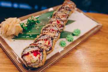 Sushi Warm Ebi Sake Unagi Spring plateau buffet in night dining restaurant flat lay. Delicious Smoked salmon rolls flesh seaweed and ginger. The norwegian salmon and Fish.