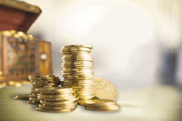 Pink piggy bank and coins on background