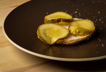 Pickles on a biscuit on a plate