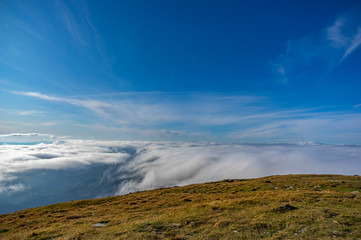 Mountains covered in fog in autumn day