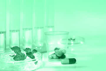 Peppermint capsules, research and development, mentol research background toned in neo mint color