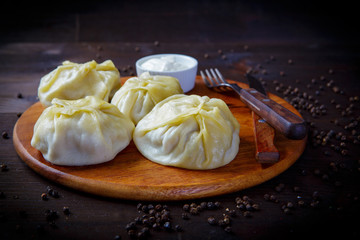 Ravioli or manti. Italian cuisine dishes for the restaurant menu. Wooden background.