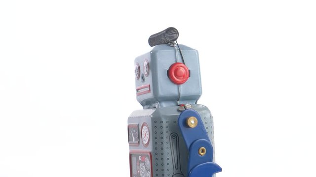 Vintage retro toy of a typical metal robot looking funny.