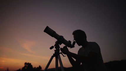 Astronomer with a telescope watching at the stars and Moon. My astronomy work.