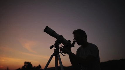 Astronomer with a telescope watching at the stars and Moon. My astronomy work.