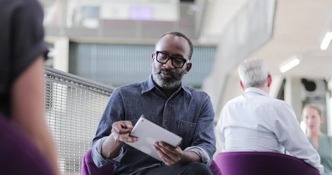 African American businessman using a digital tablet in a meeting