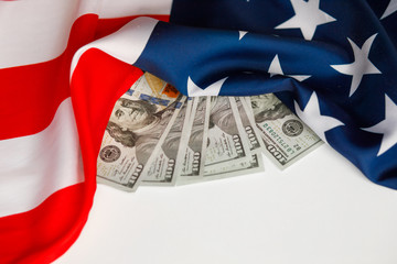 American Dollars Cash Money.  One hundred dollars banknotes close-up on  USA flag background
