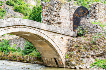 Lumbardhi, Kosovo - July 28, 2019. Old bridge and gate to Monastery of the Holy Archangels