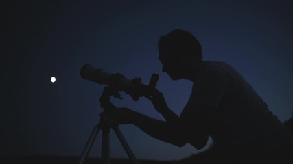 Astronomer with a telescope watching at the stars and Moon. My astronomy work.