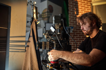 Behind the scenes of filming films or video products and the film crew of the film crew on the set in the pavilion of the film studio.