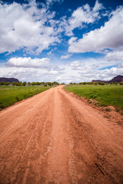 Dirt road with sky and clouds