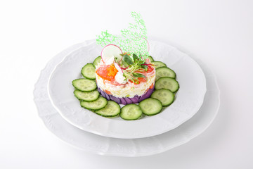 Exotic seafood salad: salmon, avocado, cocktail shrimps, caviar, purple potatoes and greens with vegetables. Banquet festive dishes. Gourmet restaurant menu. White background.