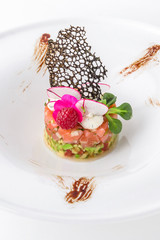 Luxury Salmon tartare with avocado and caviar. Banquet festive dishes. Gourmet restaurant menu. White background.